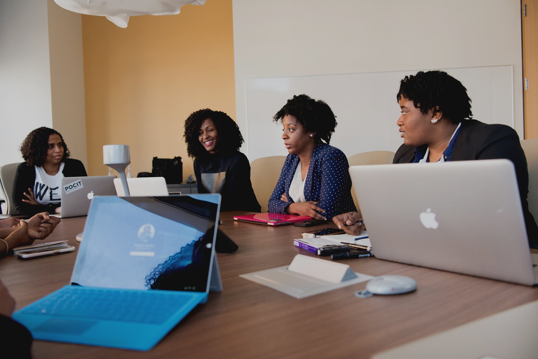 3 Women Sitting at the Table With Macbook Pro