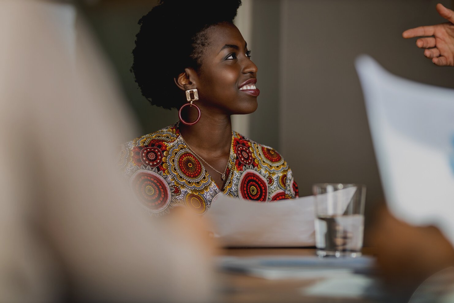 Beautiful young confident professional black african business woman smiling in meeting