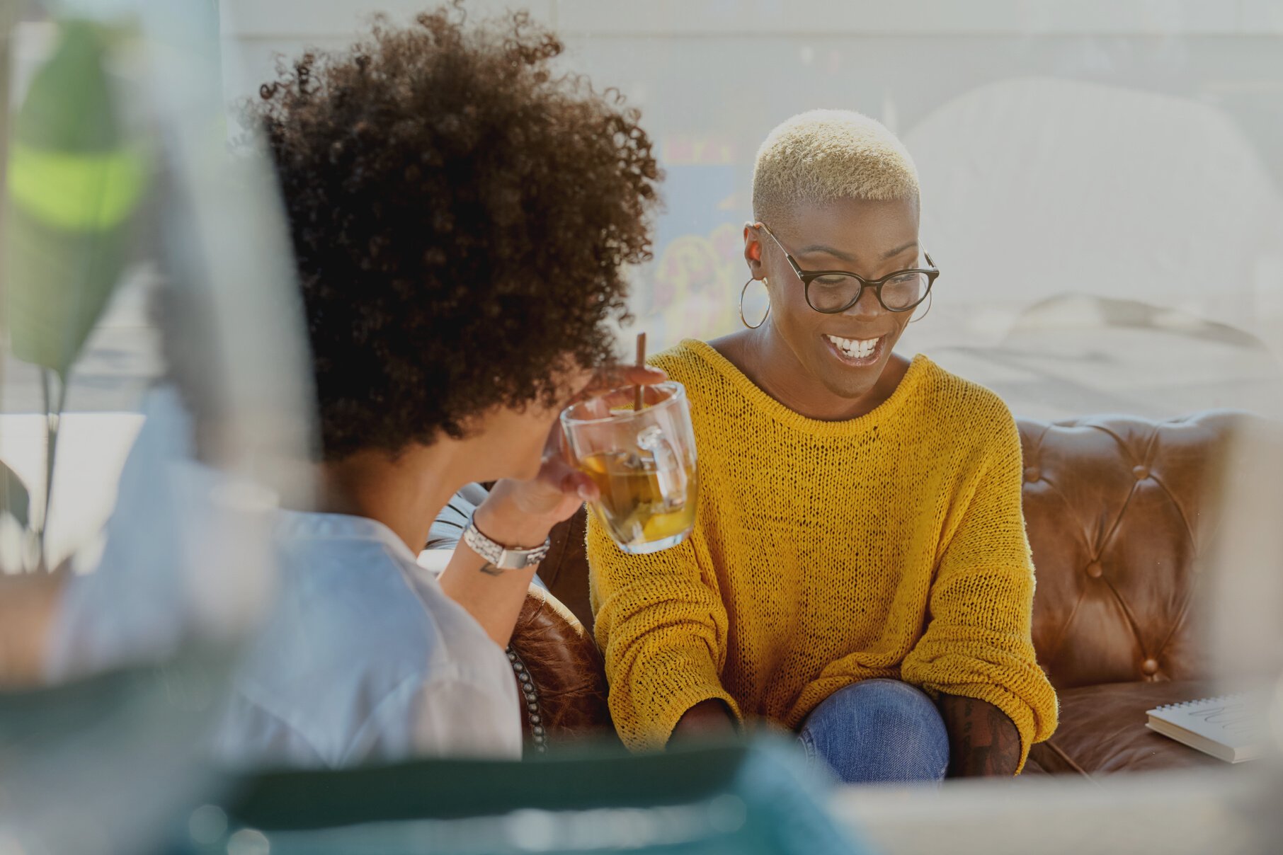 Happy black women talking at home